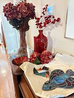 Overall lot showing vases, bowl, stained glass pieces and florals on table