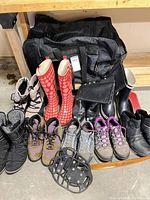 Group view of nine shoe pairs, duffel bag, traction cleats