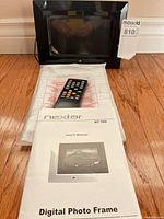 Front view of frame with remote, manual and sleeve