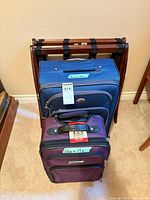 Front view of both suitcases and luggage rack