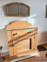 Front view of cabinet with matching mirror mounted above
