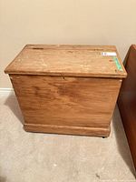 Front and side view of solid wood blanket chest on floor