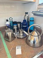 Group view showing all kettles, flasks, mugs, bottles, cups and accessories on countertop