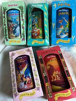 Front view of all five boxed cups showing titles and artwork