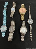 All six wristwatches displayed for size and style reference