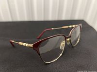 Full view of Burberry burgundy and gold half-rim eyeglass frames