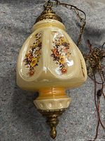 Full view of pendant lamp showing glass shade, metal fittings, chain and cord