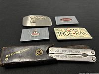 Multitool in sheath with four belt buckles laid out