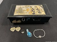 Closed jewelry box with all jewelry pieces displayed