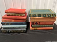 Two stacks showing all twelve hardcover books, various colors and sizes