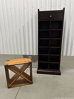 Tall dark cherry shelving cabinet and square barn-style box side by side