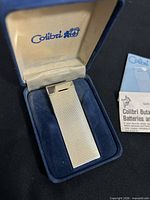 Lighter in open presentation box with paperwork visible