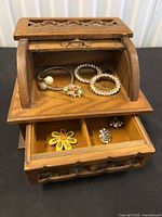 Box open showing roll-top compartment, drawer and included jewelry pieces