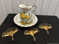 Pitcher, basin and three metal leaf wall hooks displayed together