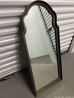 Full front view of mirror leaning against wall