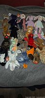 Entire assortment of Ty Beanie Babies spread on bed