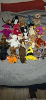 All 20 Ty Beanie Babies laid out on bed