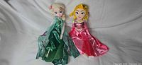 Both Disney Princess plush dolls side by side