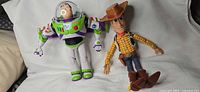 Buzz Lightyear figure and Sheriff Woody doll side by side for scale and full view