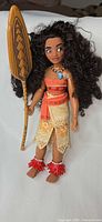 Full view of Moana doll holding paddle