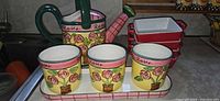 Full set showing watering can, three cups on tray, stack of five ramekins