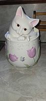 Front view of Lenox kitten cookie jar with tulips and butterfly