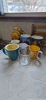 Group shot of all mugs and glass on counter