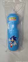Front view of sealed blue plastic Sonic water bottle showing character graphic
