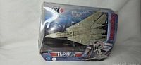 Front of box showing jet inside, Top Gun branding, damaged plastic blister
