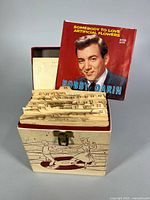 Open record case showing index dividers and visible Bobby Darin 45 sleeve