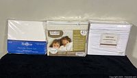 Three sealed queen sheet sets