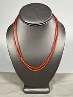Necklaces displayed on bust showing color and strand length