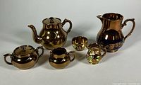 All six pieces in lot: Gibson teapot set, Wade pieces, additional pitcher