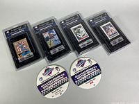 Four sealed plaques and two round championship pins laid out on table