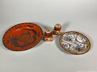 Chinese dragon plate, Japanese Kutani plate and pair of porcelain inkwells displayed together