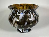 Front view of multicolour hand blown glass bowl on pedestal foot