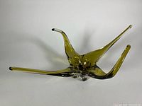 Oblique view showing triple-arm freeform shape and colour gradient