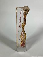 Front view of glass sculpture showing internal inclusions