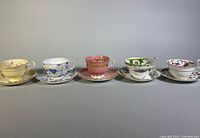 Front view of the five teacup and saucer sets