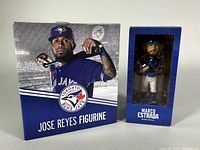 Front view of both boxed collectibles: José Reyes figurine box and Marco Estrada bobblehead box