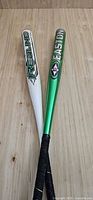 Two Easton softball bats upright showing full length, colors, and grips
