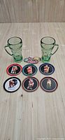 Entire lot: two green mugs, eight coasters, six bottle caps