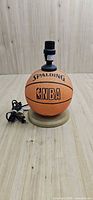 Front view of basketball lamp base showing Spalding NBA logo and socket