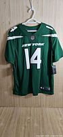 Front view of green New York Jets Sam Darnold #14 jersey with tags