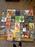 All 30 Hardy Boys hardback books laid out on a table, showing dust jackets and one jacket-less volume