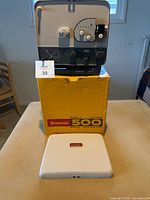 Kodak Brownie 500 projector on top of original yellow box with separate white cover