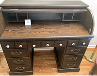 Front view of roll-top secretary desk with interior cubbies and drawers visible