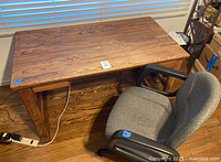 Top view of wood desk with chair tucked underneath