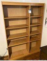 Front view of full bookcase showing shelves and central divider