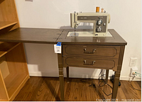 Machine mounted in cabinet with leaf extended